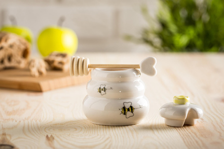 Porcelain honey pot with wooden dipper