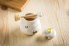 Porcelain honey pot with wooden dipper